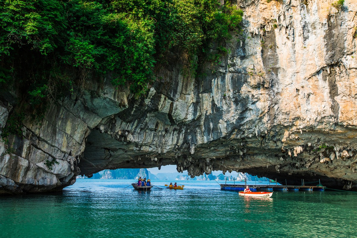 The magnificent scenery of towering limestone formations emerging dramatically from the tranquil waters in Ha Long Bay