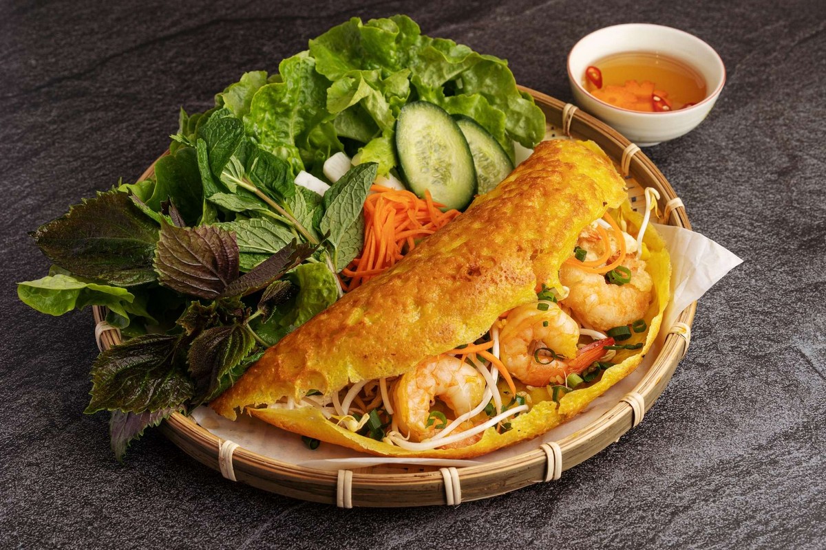Best Local Food in Saigon - Banh Xeo, a Vietnamese pancake, offers a delightful contrast of textures and flavors