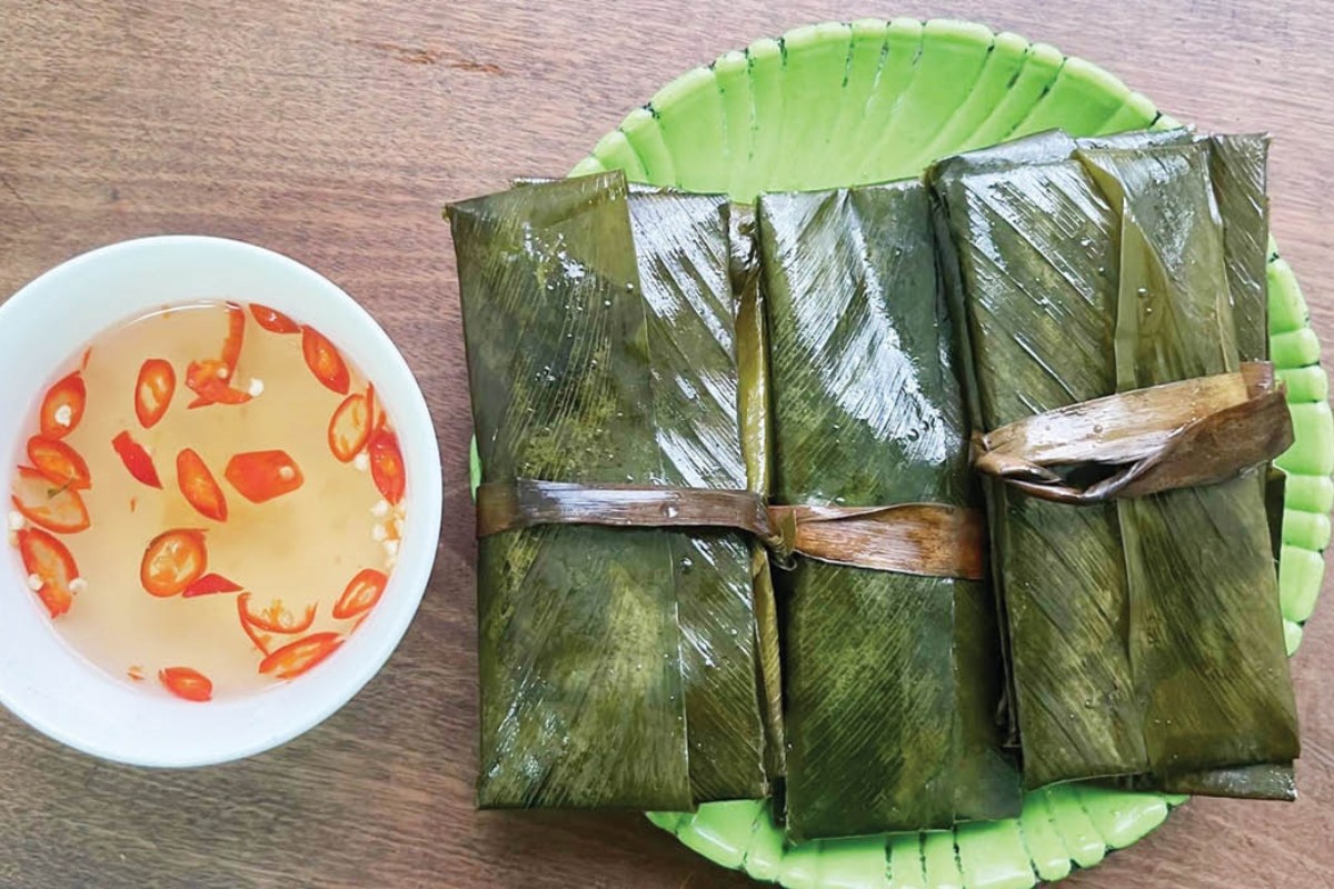 Prepare Banh Nam by steaming them after mixing rice flour, shrimp, pork and wrapping in banana leaves