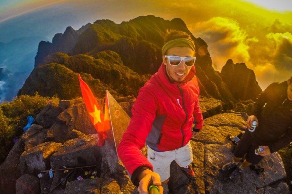 Celebrate your achievement with a selfie at the stunning Fansipan Mountain summit in Vietnam